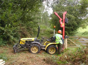 our compact tractor with post driver making short work of a chestnut strainer